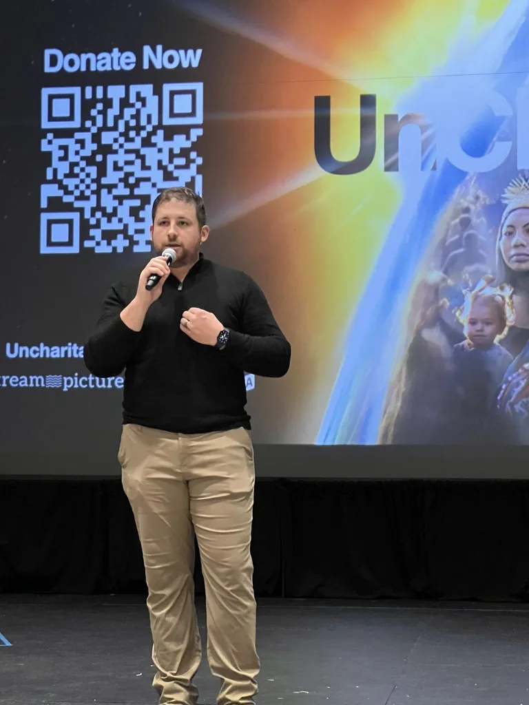 Vince Cain speaking at the Louisville premiere of the documentary UnCharitable in 2023